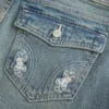 Dżinsy bootcut z niskim stanem, haftem motyla i średnim wypraniem Dżinsy bootcut z niskim stanem, haftem motyla i średnim wypraniem