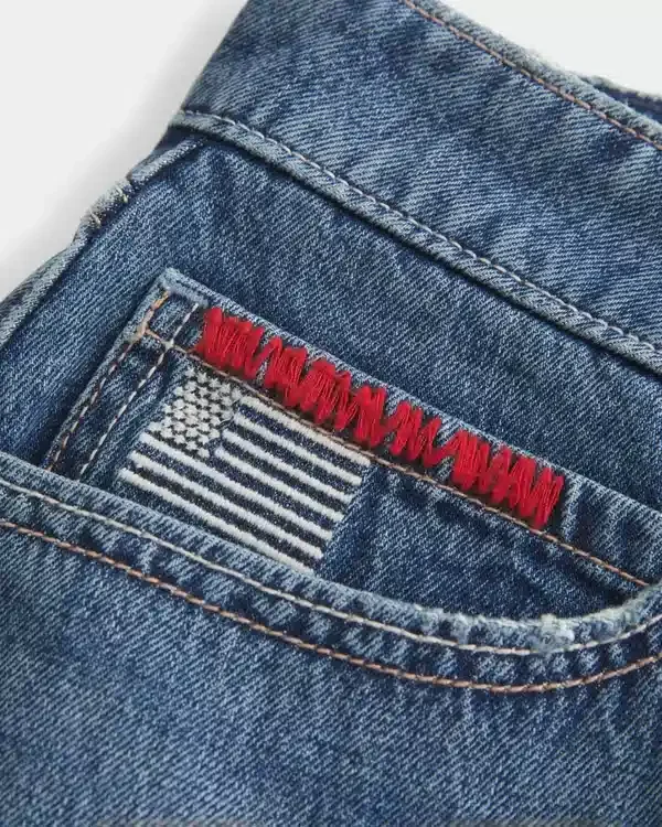 Mini spódniczka jeansowa z niskim stanem, średnim wypraniem i haftowaną flagą Mini spódniczka jeansowa z niskim stanem, średnim wypraniem i haftowaną flagą