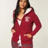 Świąteczna kolekcja Sherpa-Lined Zip-Up Logo Graphic Hoodie Świąteczna kolekcja Sherpa-Lined Zip-Up Logo Graphic Hoodie
